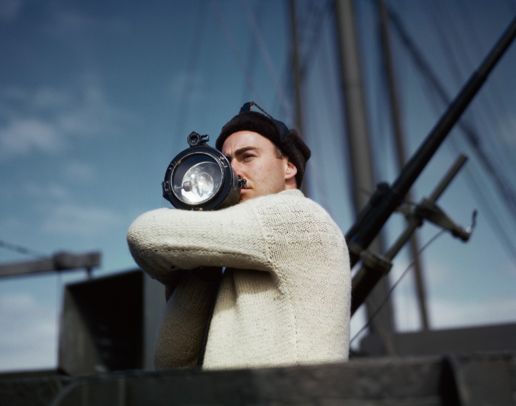 15. Capa_A crewman signals another ship of an Allied convoy across the Atlantic from the U.S. to England
